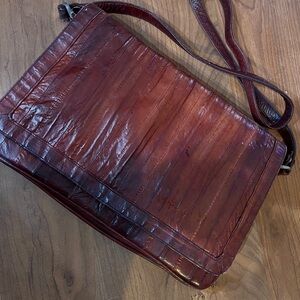 Vintage genuine eel skin leather shoulder bag in a burgundy or oxblood color.